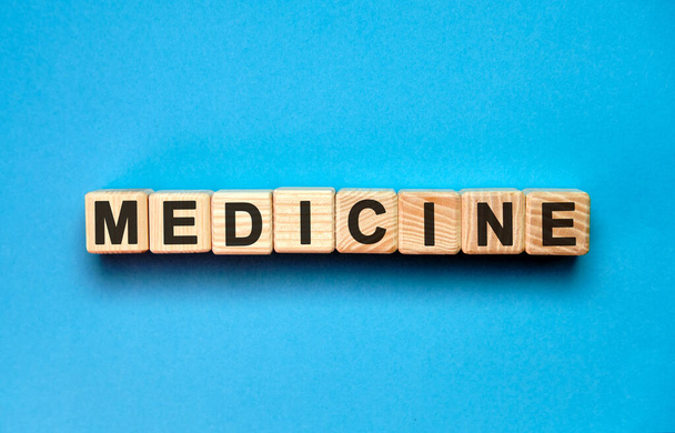 MEDICINE word cube on a blue background. Medical concept. - Zdjęcie, obraz