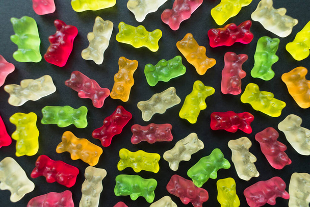 Jelly bears on a black background. Background from jelly bears. - 写真・画像