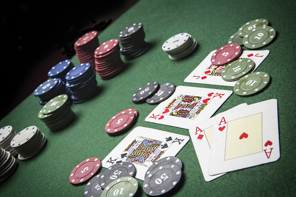 Cards poker deck English, poker chips stack on green table - 写真・画像