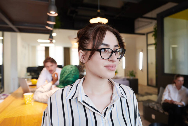 portrait of businesswoman in casual clothes with glasses at modern startup open plan office interior - Fotó, kép