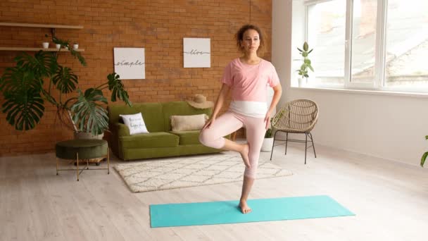 Pregnant African-American woman practicing yoga at home - Video, Çekim
