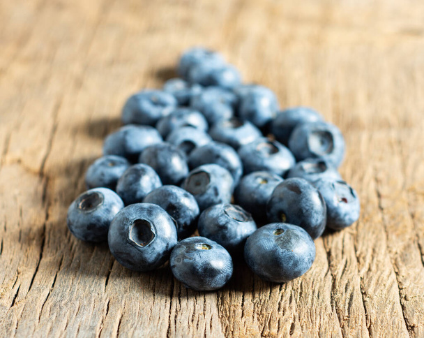 Healthy eating concept. Fresh organic blueberries on a wooden background - Photo, Image