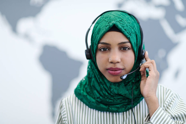 African muslim female with green hijab scarf customer representative business woman with phone headset helping and supporting online with customer in modern call centre - Foto, Imagem
