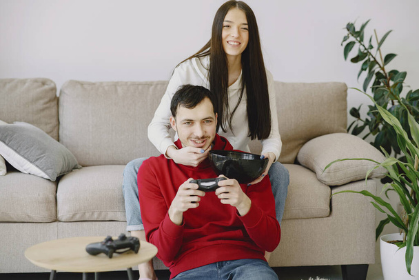 Couple at home playing in a video games - Photo, image