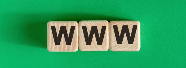 WWW text on wooden cubes on a green background - Photo, Image