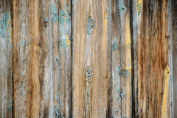 The texture of the building's surface is made of old wooden planks of gray and brown. Vertical direction of boards - Фото, зображення