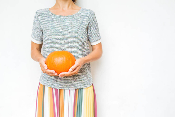 Women with pumpkin in hands. Autumn Halloween or Thansgiving concept - Φωτογραφία, εικόνα