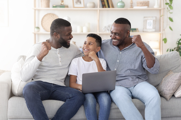 Happy Black Father Son And Grandfather Celebrating Success With Laptop At Home - Photo, Image