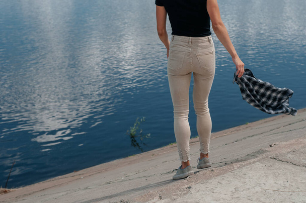 Front view of a long women legs posing with jeans - Fotó, kép