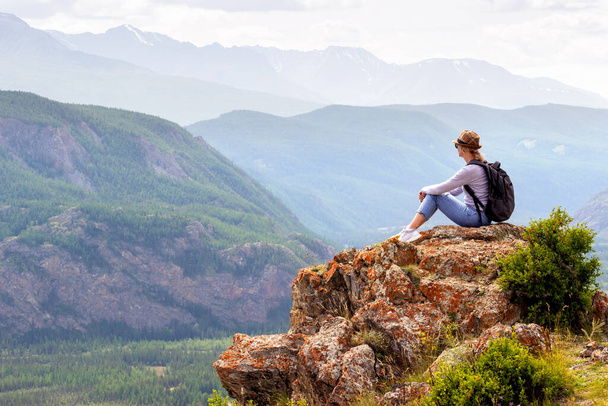 Hiker with backpack enjoying valley view. - 写真・画像