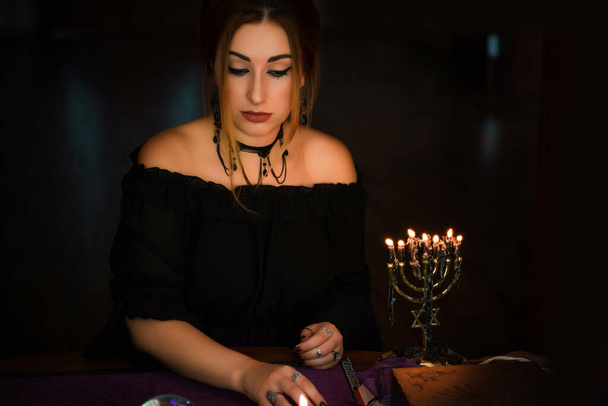 Woman holding candles, mystical scene , Concept of magic rituals and wicca - Foto, afbeelding