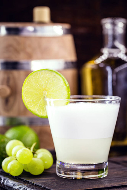 Pisco sour, a typical cocktail of South American cuisine, Peru and Chile, prepared based on pisco and lemon, sweetened with brandy, eggs, served cold. - Photo, Image