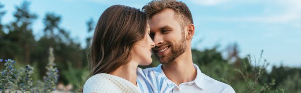 horizontal image of happy couple smiling and looking at each other  - Фото, изображение