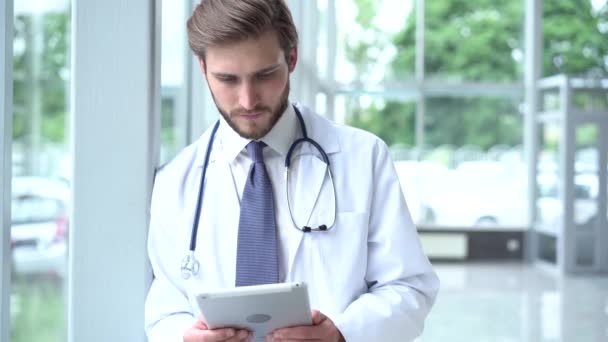 Doctor using digital tablet in hospital corridor. - Video
