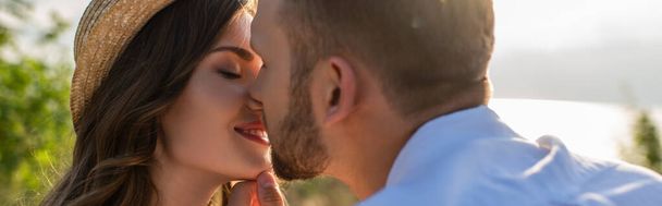 panoramic concept of bearded man kissing happy young woman  - Photo, Image
