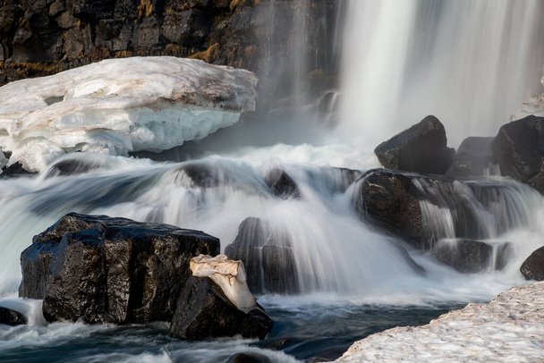 Water from waterfall splashing on a rocky river Iceland - Photo, Image