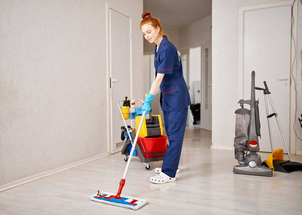 Maid woman with mop. House cleaning service concept. - Photo, image