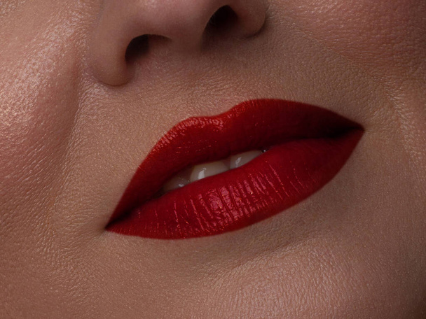 Perfect red lip maqullage. Close up macro cropped photo with beautiful attractive female mouth, wellness, wellbeing, treatment, therapy concept, lips with a sense of charity - Foto, immagini