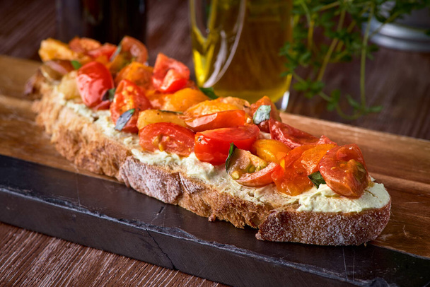 Bread toast with salted salmon, pesto sauce and cream cheese ricotta. Gourmet snack. selective focus. - 写真・画像