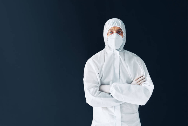 Confident doctor with crossed arms in protective medical suit with copy space - Valokuva, kuva