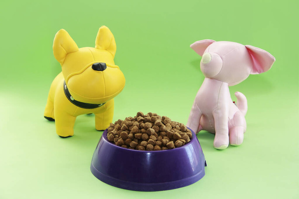 dry dog food and children's toy yellow dog - Photo, Image