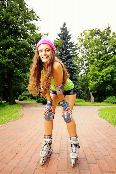 woman roller skating sport activity in park - Фото, изображение