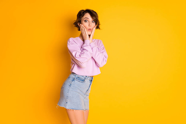 Portrait of astonished youngster girl hear from her friend incredible rumor impressed touch hands face stare stupor wear good look pullover isolated over vivid color background - 写真・画像