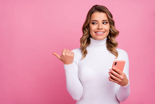 Close-up portrait of her she nice-looking attractive lovely charming lovable cheerful cheery wavy-haired girl using pointing thumb aside advert ad isolated on pink pastel color background - Foto, immagini