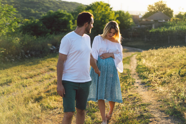 Happy and young pregnant couple in outdoors - Photo, Image