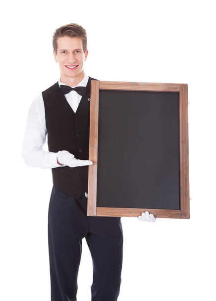 Male Waiter Holding Chalkboard - Foto, afbeelding