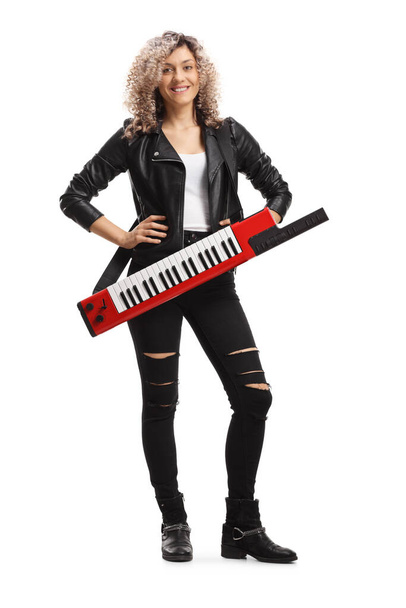 Full length portrait of a female musician with a keytar synthesizer isolated on white background - Foto, afbeelding
