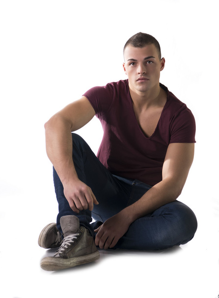 Full body shot of handsome young man sitting on floor - Foto, Bild