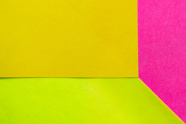 Yellow, green and pink paper pattern arranged in the background - Foto, Imagem