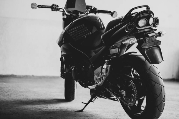 Black motorcycle on the background of underground parking. - Photo, Image