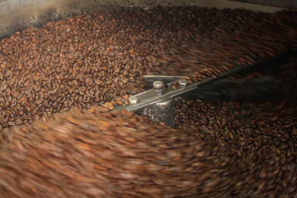 moving Industrial coffee roaster with coffee beans  - 写真・画像