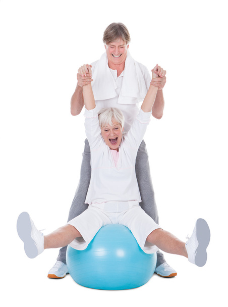 Senior Couple Exercising With Pilates Ball - Photo, image