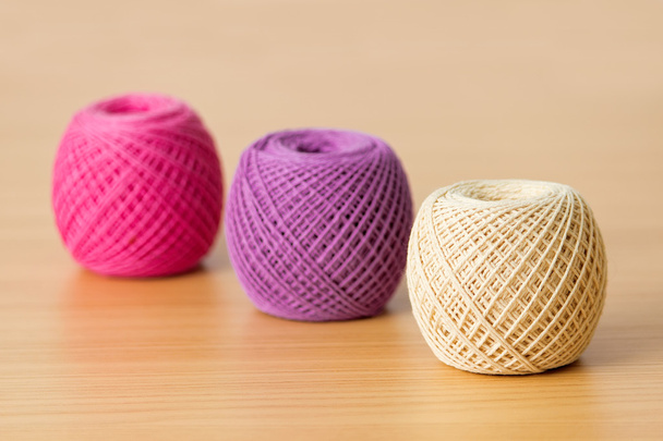 Balls of threads on a wooden table - Φωτογραφία, εικόνα