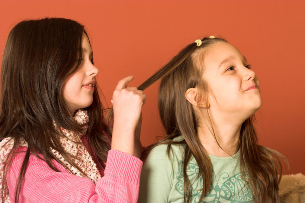Two pretty girls touching hair - Foto, afbeelding