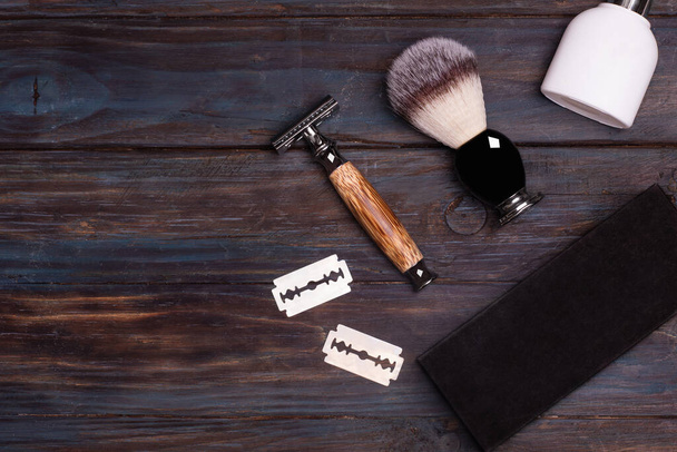 Razor, brush, perfume, balsam and shaving foam on a black background. - Photo, Image