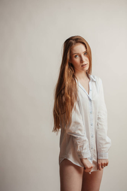 Pretty woman with long straight red hair. Female model over white background - Φωτογραφία, εικόνα