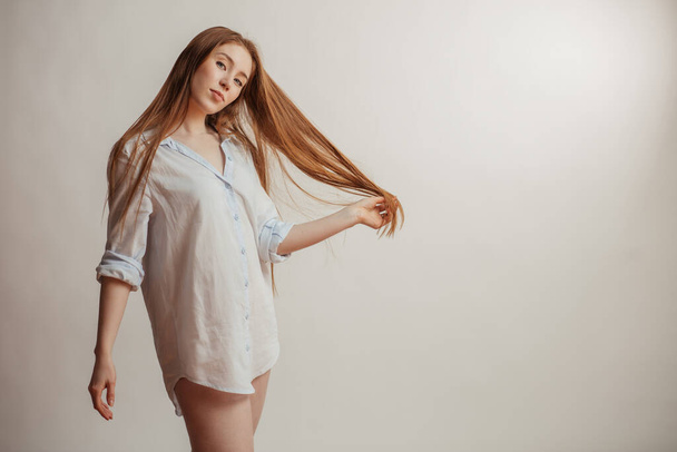 Pretty woman with long straight red hair. Female model over white background - Φωτογραφία, εικόνα