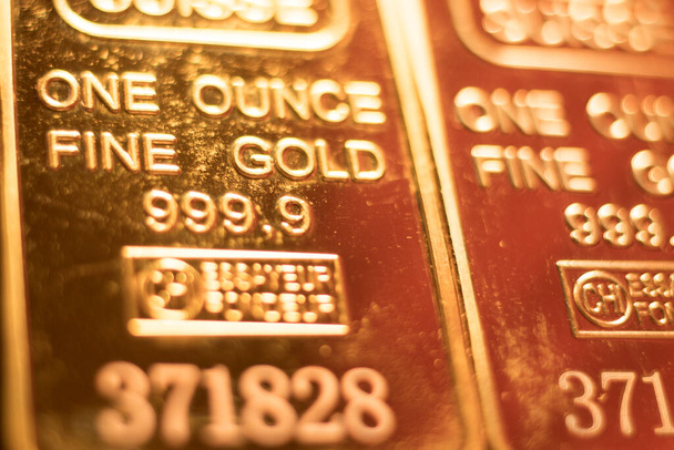 Fine solid gold 999.9 one ounce bullion ingot precious metals bar closeup isolated photo. - Photo, Image