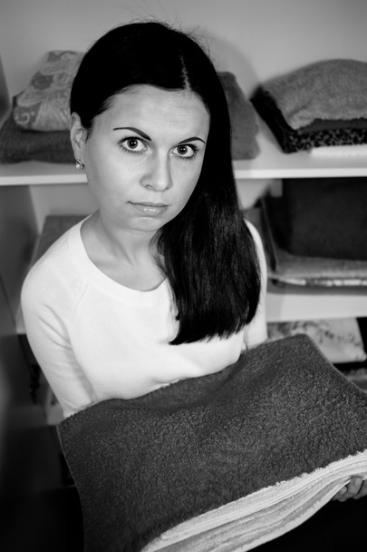 young woman holds clean towels - 写真・画像