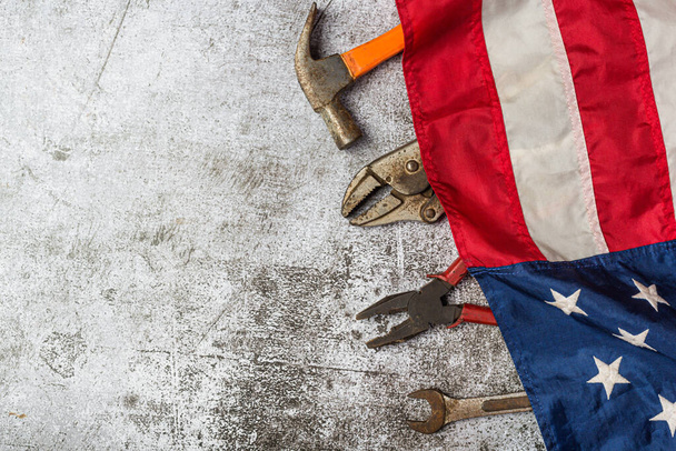 American flag and tools near the helmet Labor day concept. - Fotó, kép