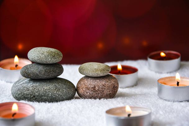 Concepto zen, piedras de balneario y velas ardientes sobre fondo borroso, Tratamiento de aromaterapia y masaje, espacio de copia para texto - Foto, Imagen