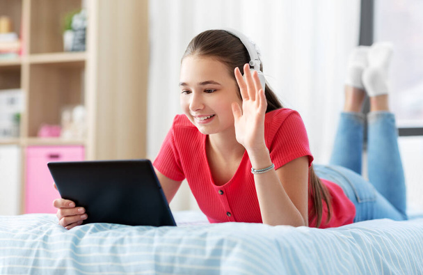 girl having vide call on tablet computer at home - Fotó, kép
