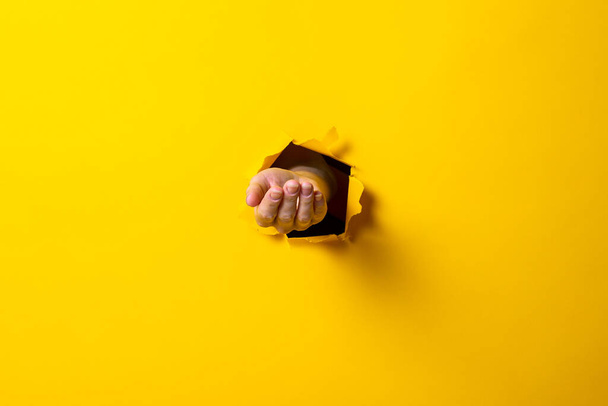 Opened male hand, palm up on a yellow background. Sign language. - Φωτογραφία, εικόνα