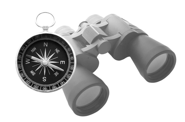Classic round travel compass and classic travel binoculars isolated on white background as symbol of tourism with compass, travel with compass and outdoor activities with compass - Photo, Image