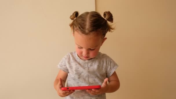 Cute toddler watching video on smartphone - Footage, Video