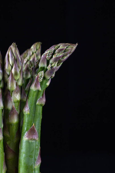 Fresh organic green asparagus  isolated on black background. closeup shot  - Foto, Bild